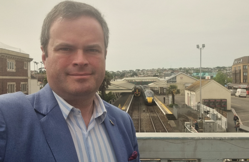 Kevin Foster MP with Paignton Station in the background.