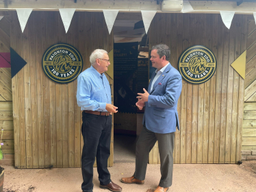Wild Planet Trust CEO Dennis Flynn talks with Kevin Foster MP at the Zoo's Centenary Exhibiton.